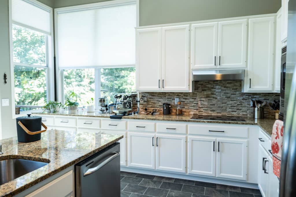 White painted kitchen cabinets with granite countertops in a Lake Oswego home